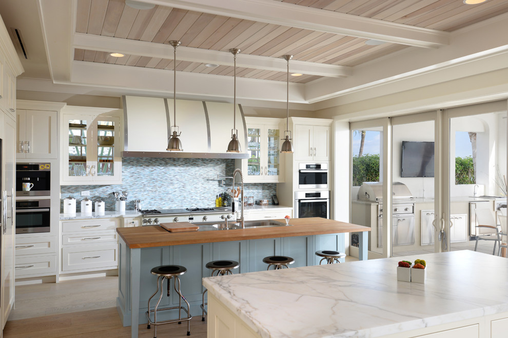 Candlelight Cabinetry for Beach Style Kitchen with Hood
