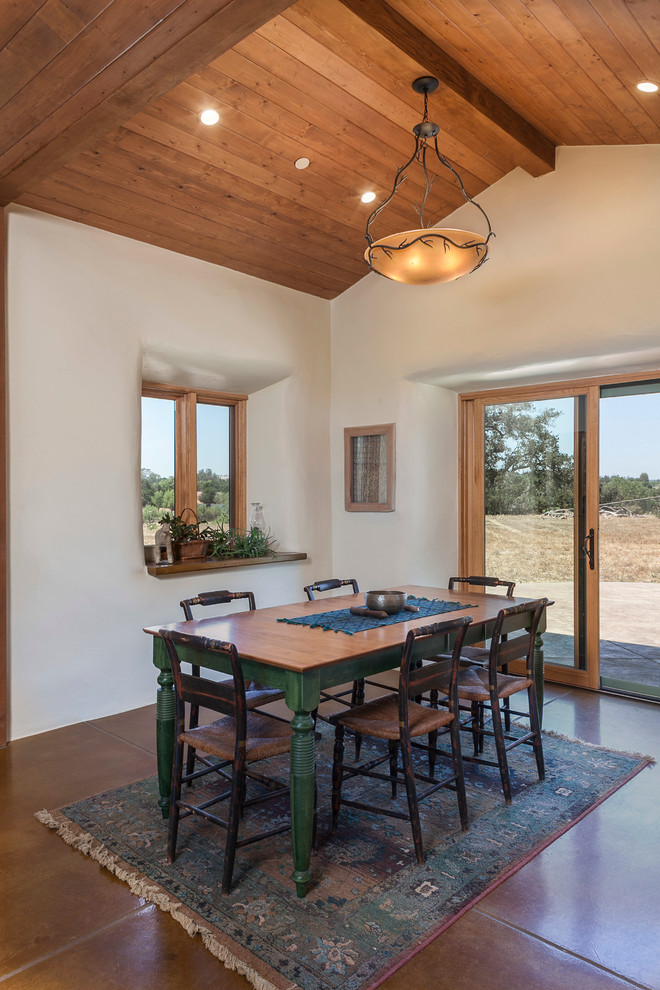Straw Bale Construction for Farmhouse Dining Room with Brown Tile Floor