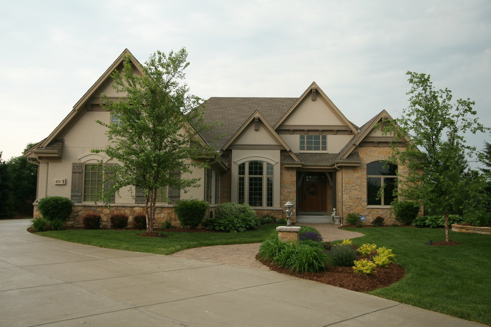 Earth Tones Paint Exterior Traditional with Bark Mulch Concrete Driveway