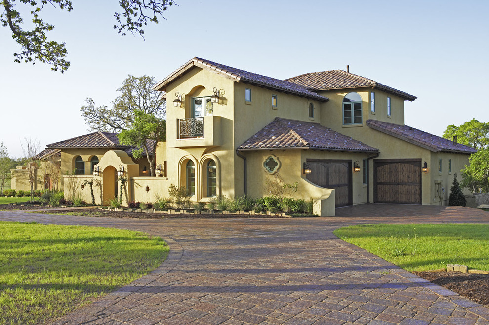 fancy garage doors Exterior Mediterranean with arched windows archway balcony