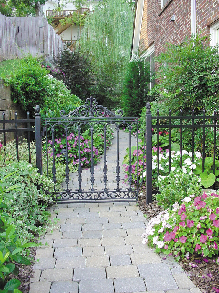 Rod Iron Gates Landscape Traditional with Brick Siding Concrete Flowers