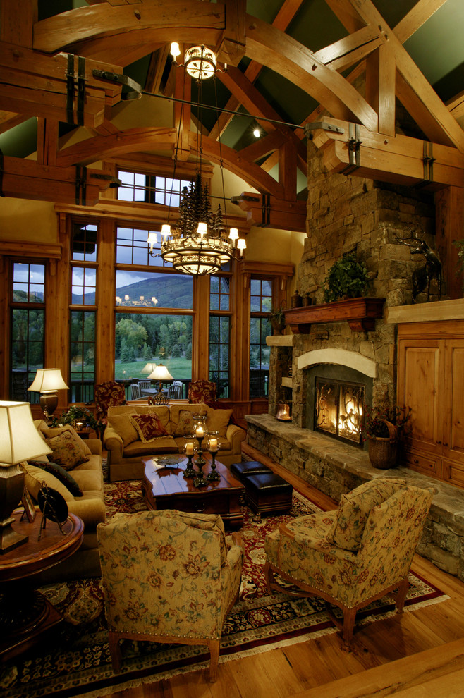 Stacked Rock Fireplace Living Room Rustic with Ceiling Beams Chandelier Fieldstone