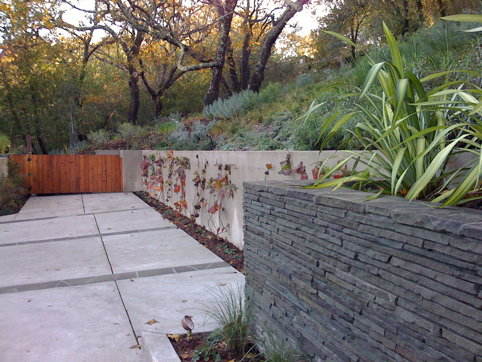 Stone Retaining Wall Landscape Contemporary with Concrete Driveway Grass Hillside