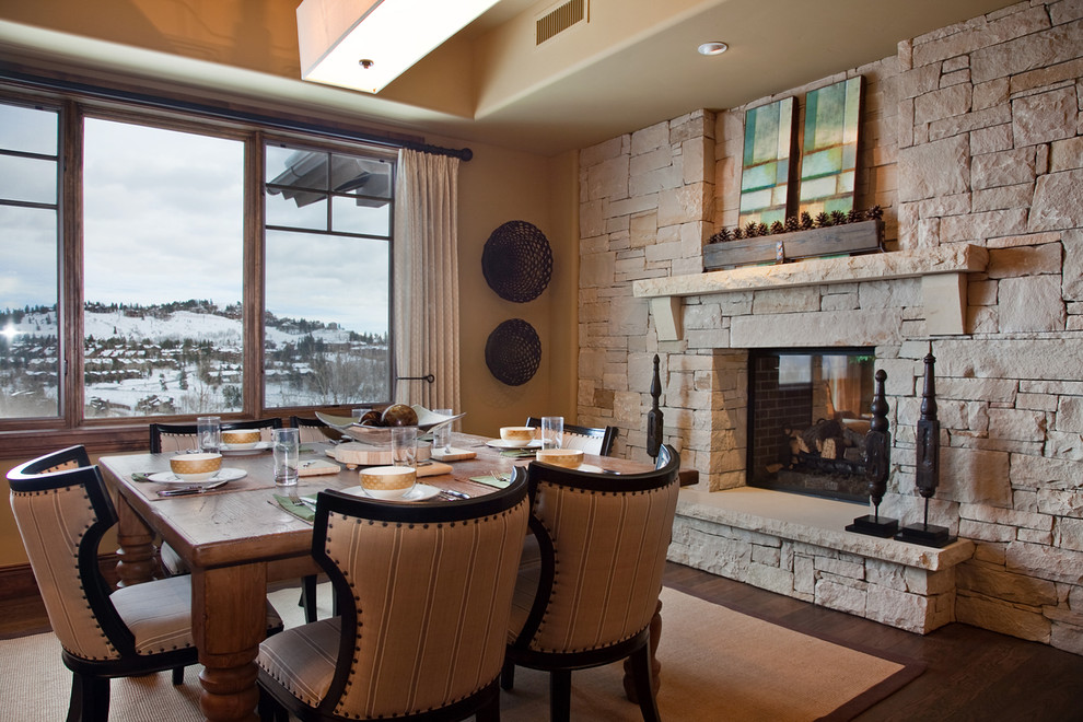 Stone Wall Fireplace Dining Room Traditional with Dark Stained Wood Floor