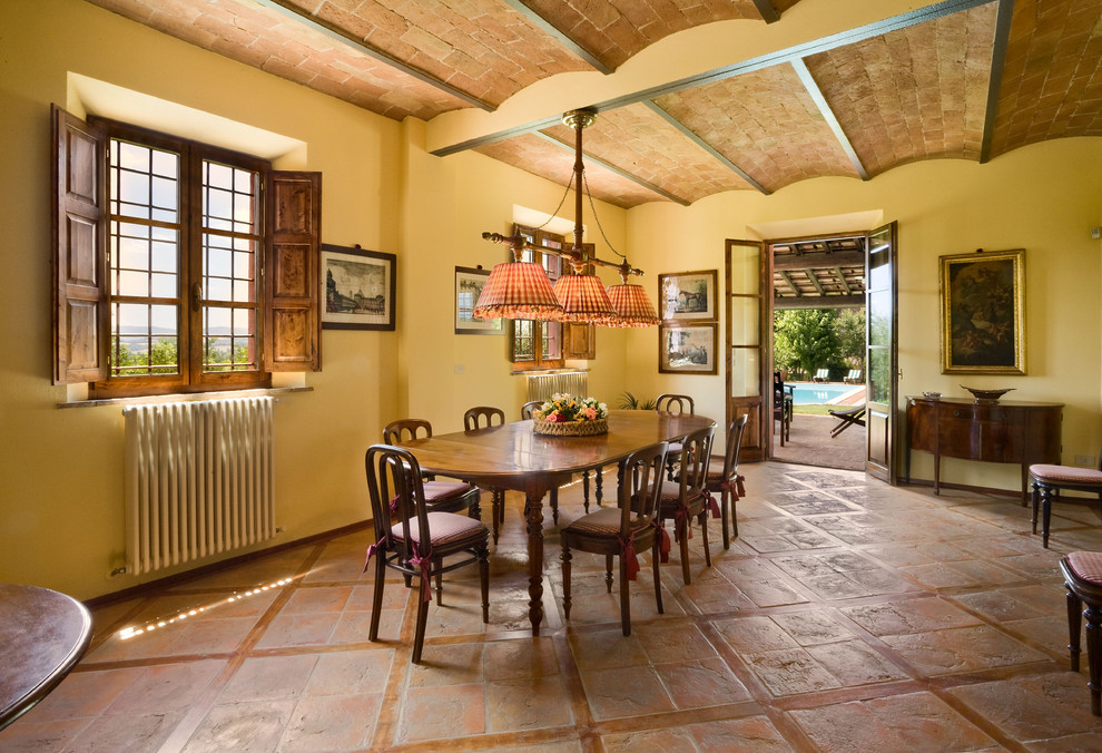 Terra Cotta Tile Dining Room Farmhouse with Brick Ceiling Casement Windows