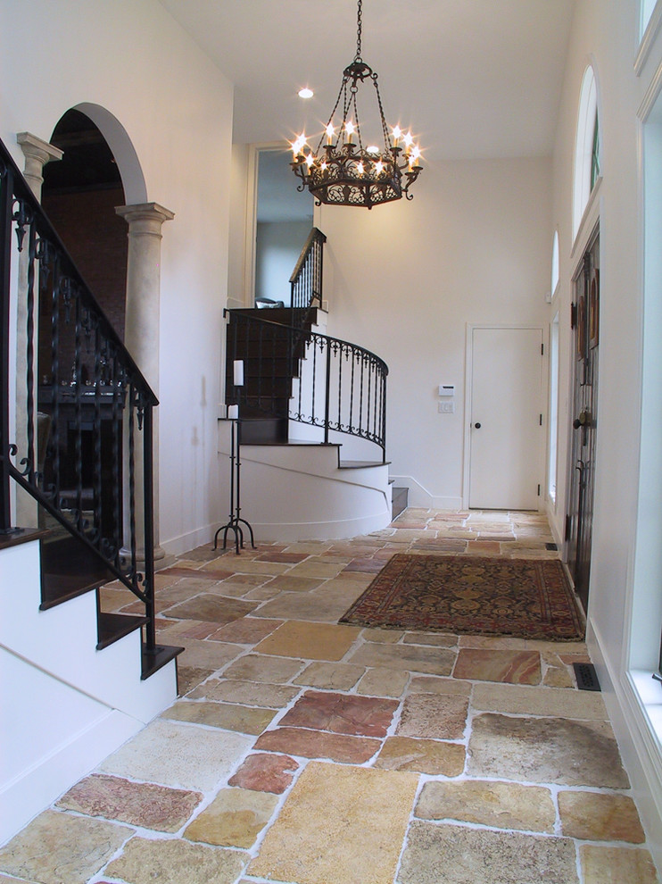 Tumbled Stone Tile Entry Mediterranean with Arch Chandelier Columns Earth