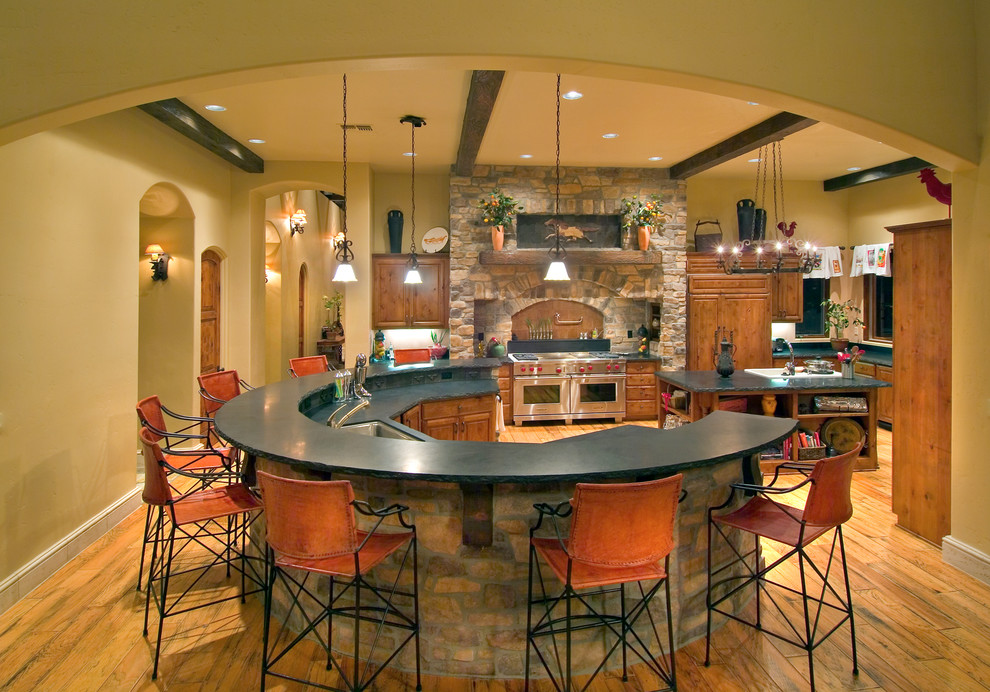 Tumbled Stone Tile Kitchen Mediterranean with Archway Black Counter Chair