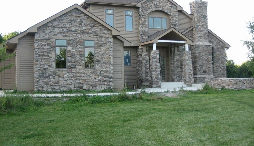 Cultured Stone Veneer Traditional Exterior with Gray Stone Pillars