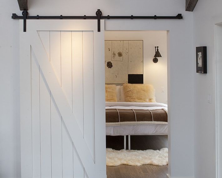 Inside Sliding Barn Doors Farmhouse Bedroom with Wood Flooring