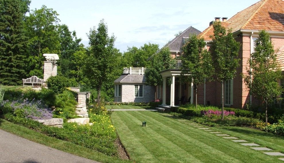 Large Retaining Wall Blocks Traditional Landscape with Driveway