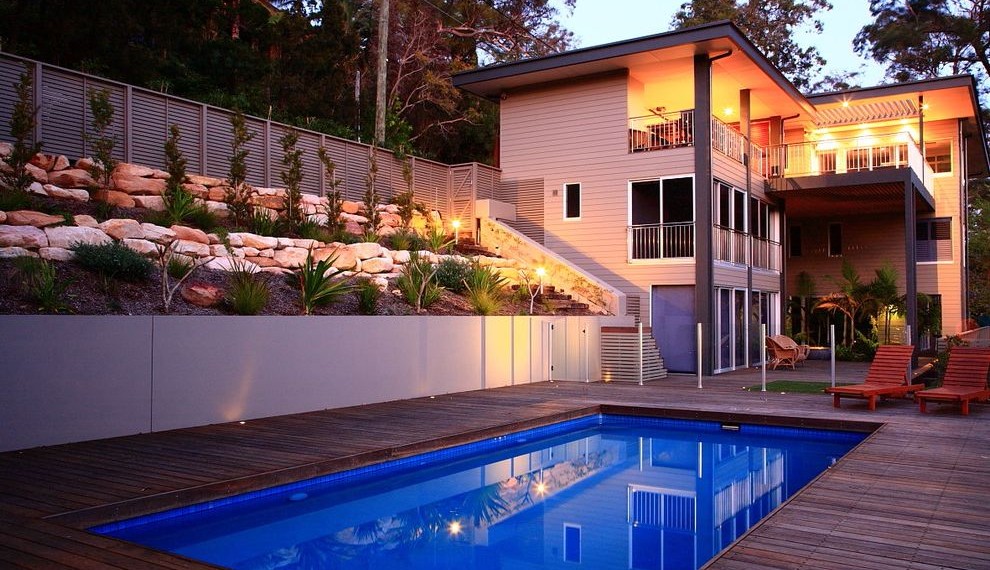 Large Retaining Wall Blocks Tropical Pool with Beach Home